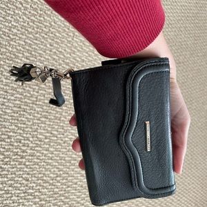 Gently used wristlet wallet with cell phone compartment. Normal wear and tear.